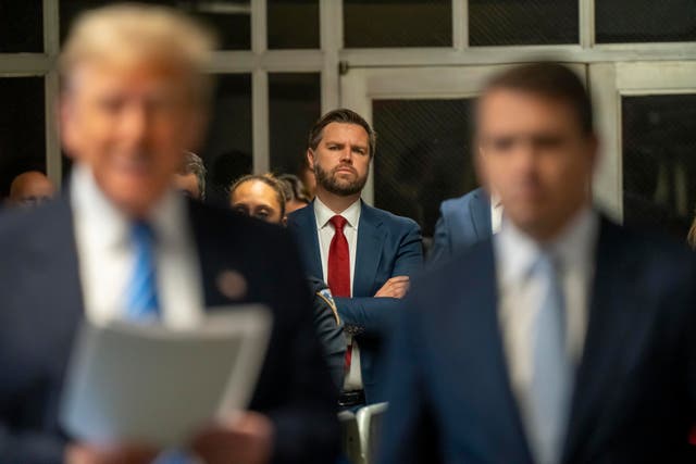 <p>JD Vance looks on as former President Donald Trump speaks to the media during his hush money trial </p>