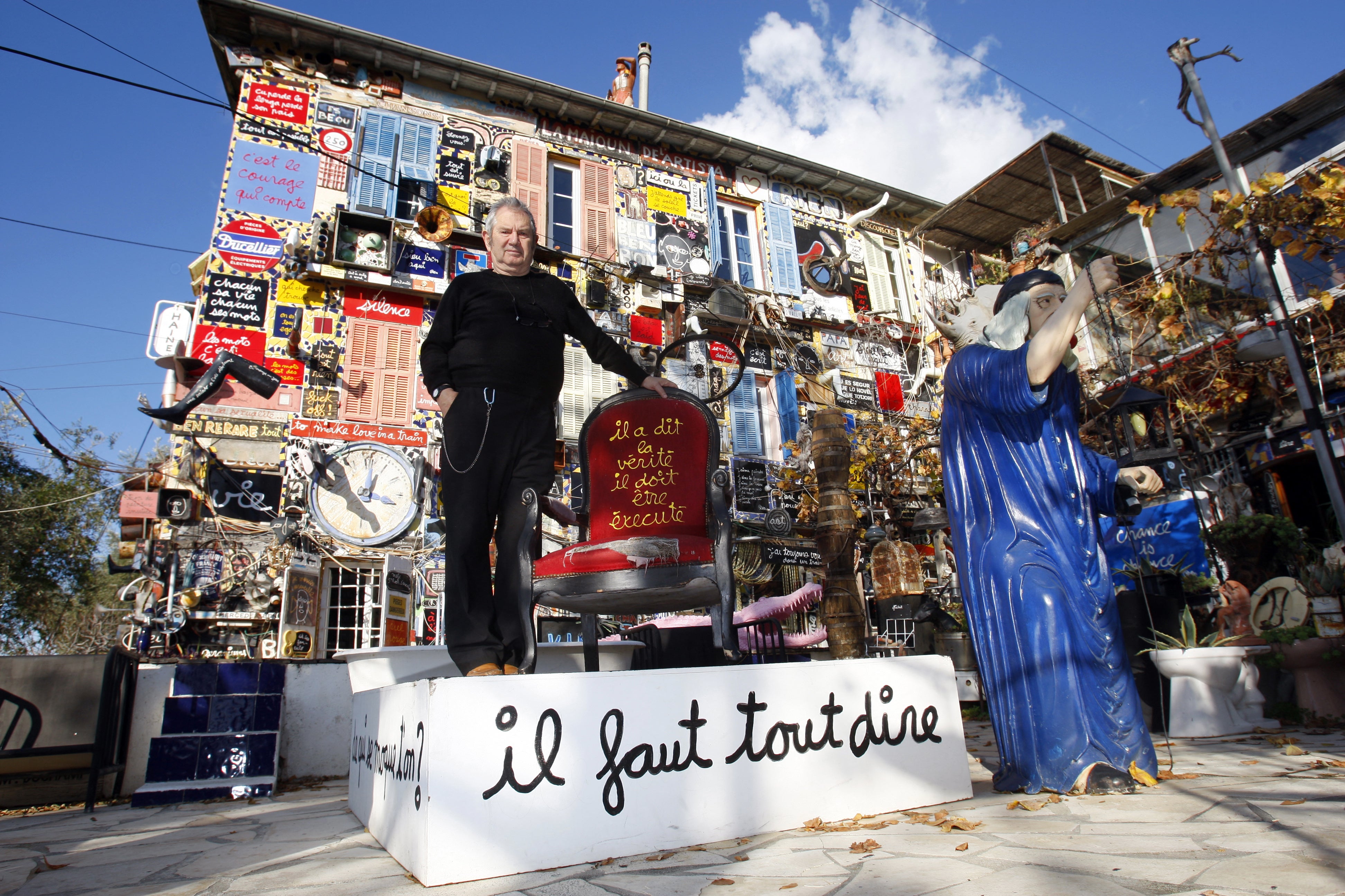 French artist Ben Vautier poses outside his home in Nice on 1 December 2009