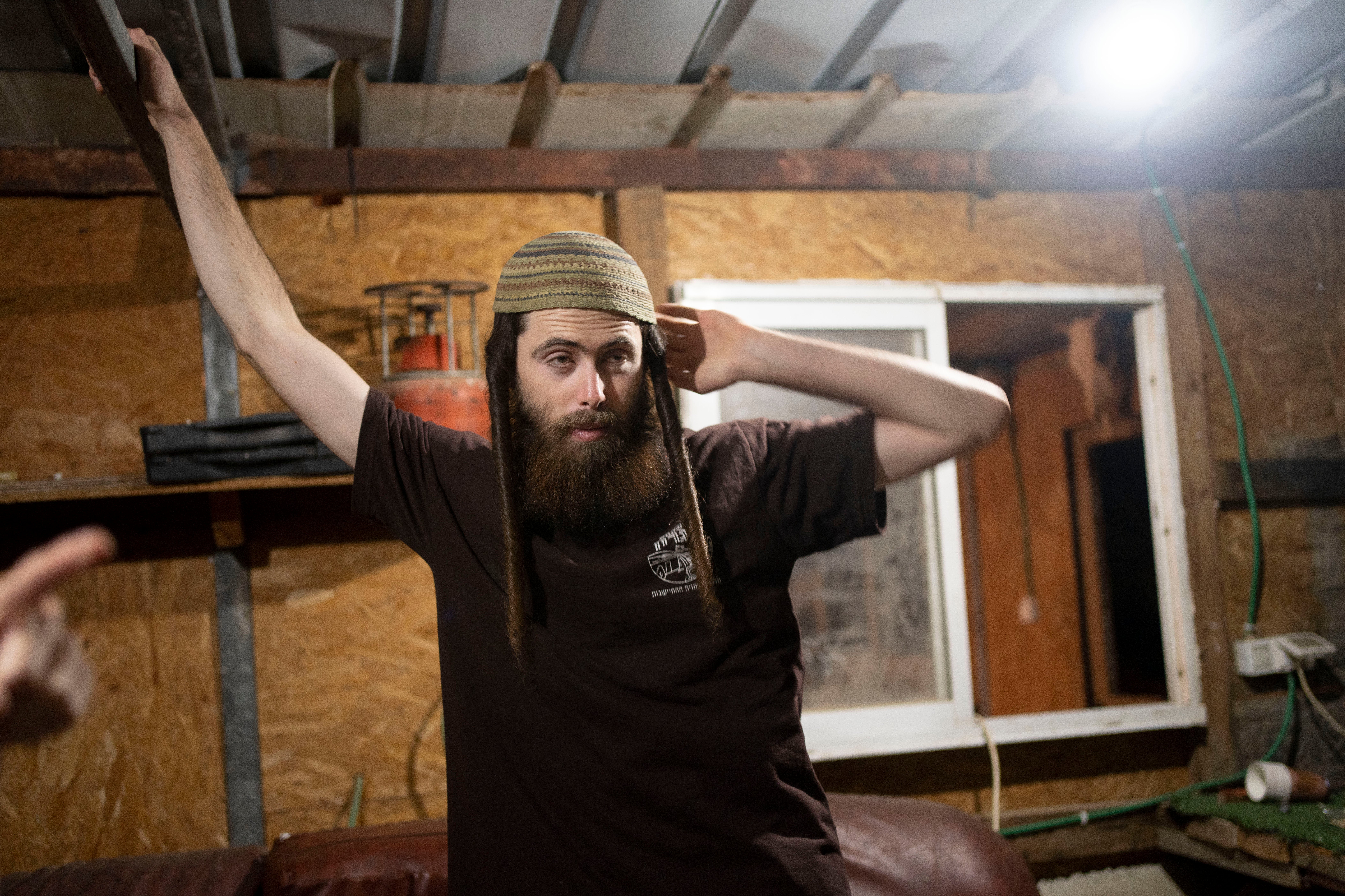Elisha Yered, an Israeli settler and leading figure of the Hilltop Youth, visits with journalists in a makeshift clubhouse near the settlement of Maskiot in the northern West Bank