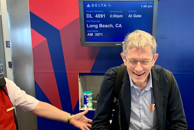 <p>Happy chap: Simon Calder after learning his Delta flight from Salt Lake City to Long Beach is overbooked, and being offered $600 to travel on a later departure</p>