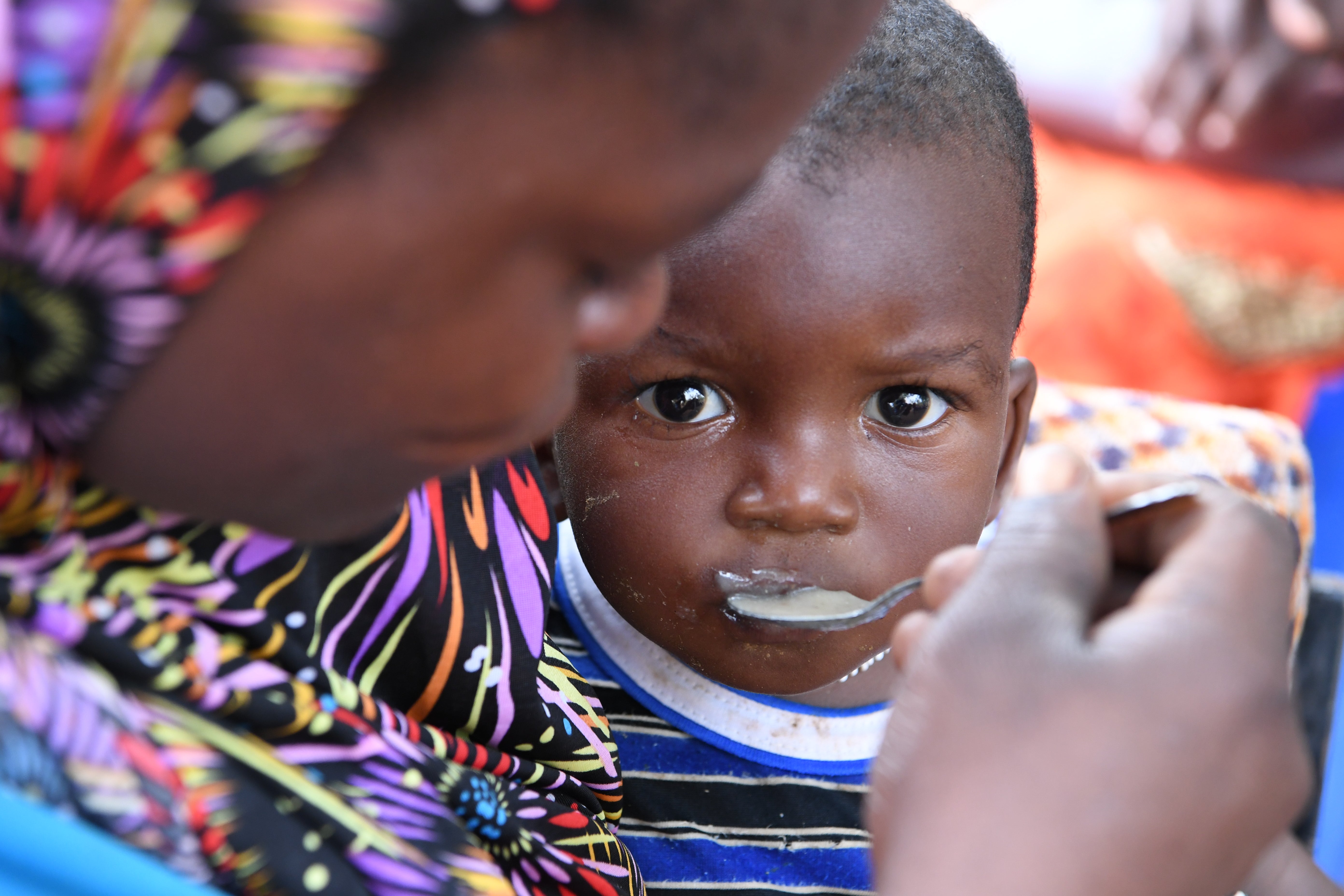 Women and children at a malnutrition screening session in the village of Ngolo, in the Northern region of Burkina Faso