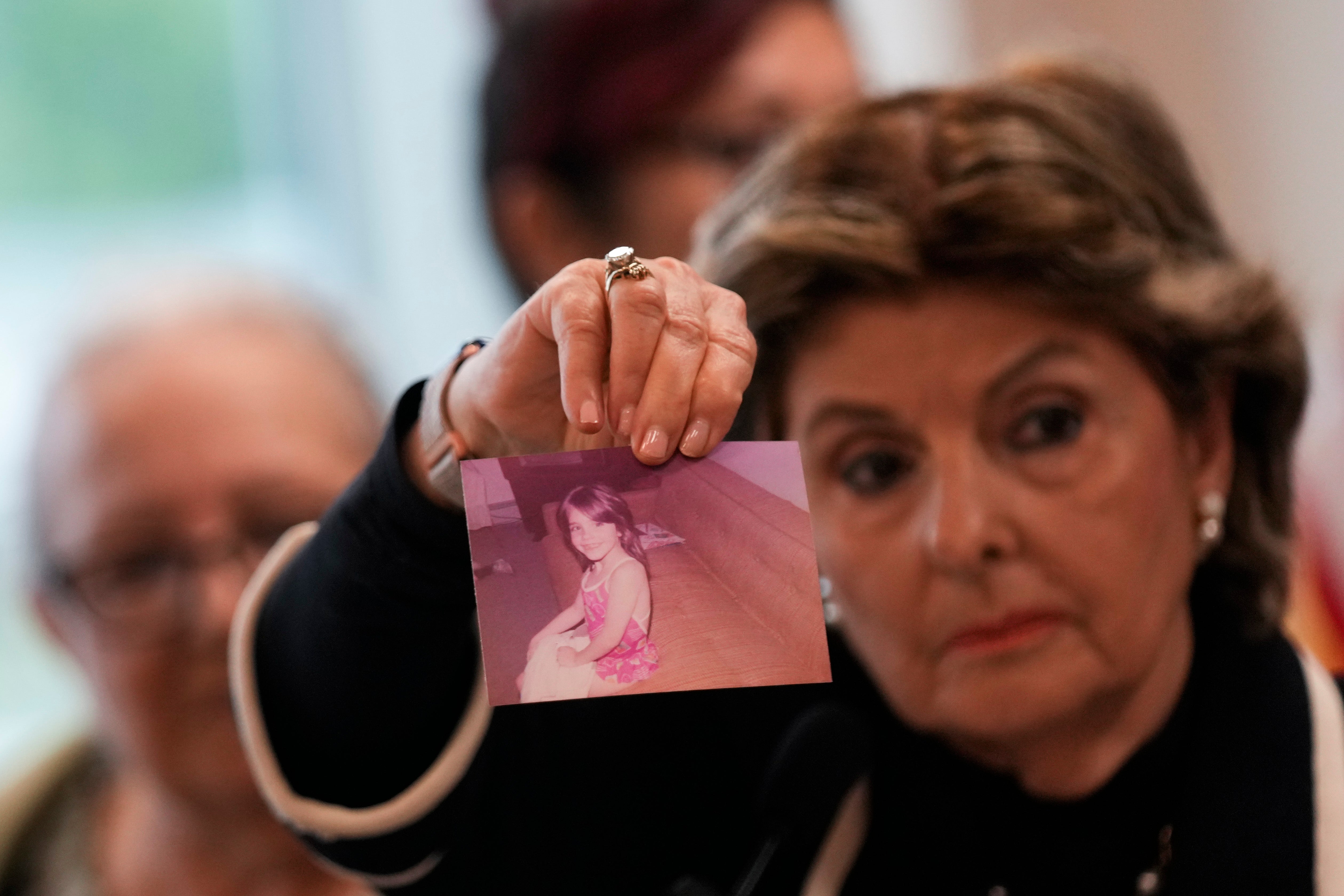 Attorney Gloria Allred holds up a picture of Jessica Taylor during a press conference on Thursday