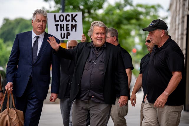 <p>A protester greets Steve Bannon as he arrives at a federal courthouse in Washington DC for setencing on June 6. </p>