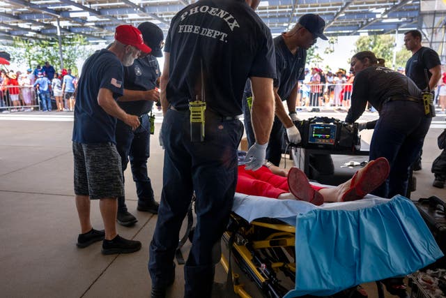 <p>A Donald Trump supporter in Phoenix, Arizona, receives medical care for heat exhaustion while waiting for a rally to begin. Trump will hold a mid-day rally in Las Vegas on 9 June, where temperatures are expected to reach 104 degrees </p>