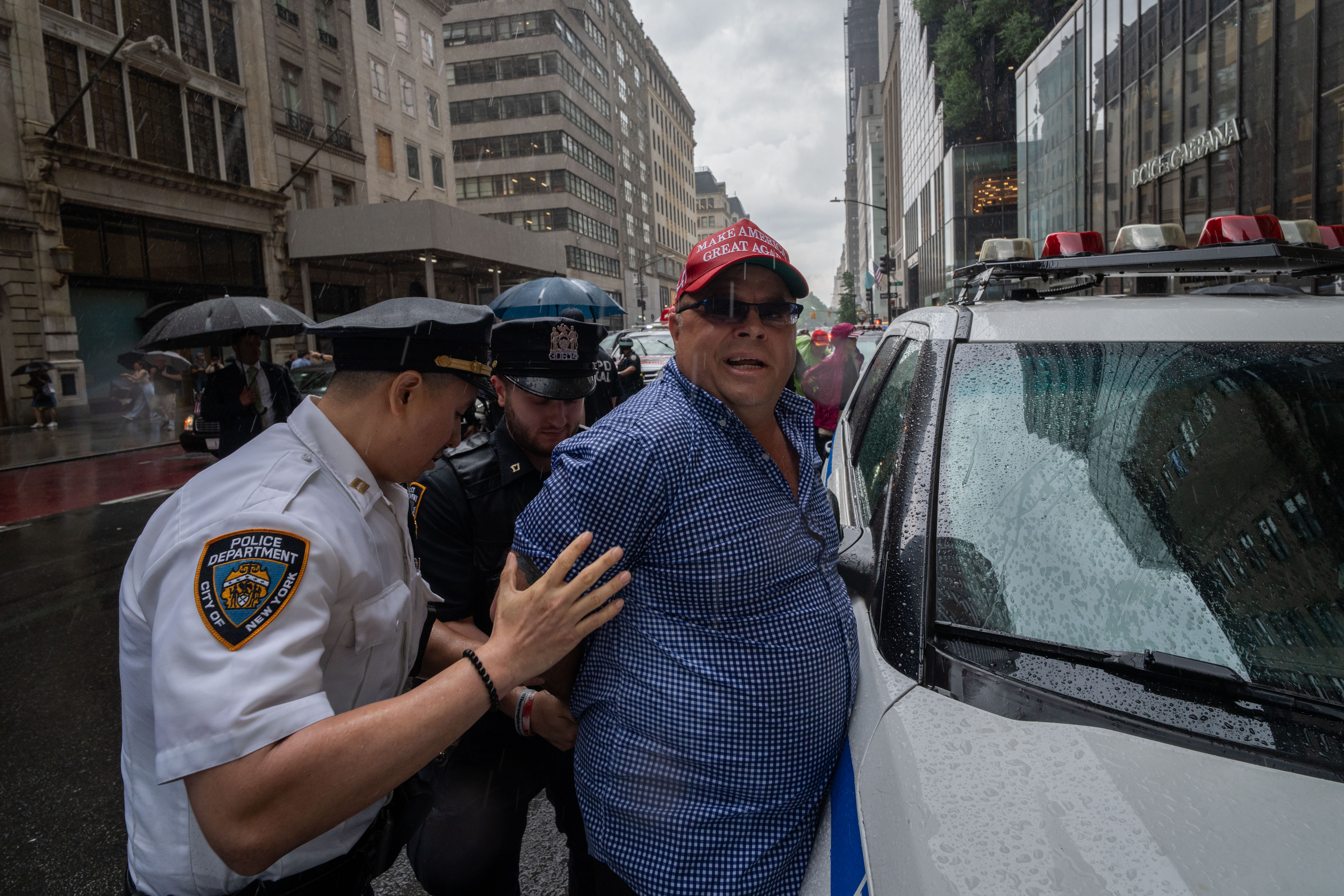 Dion Cini, a supporter of former President Donald Trump is detained by NYPD outside of Trump Tower after unveiling a giant Trump flag in the street