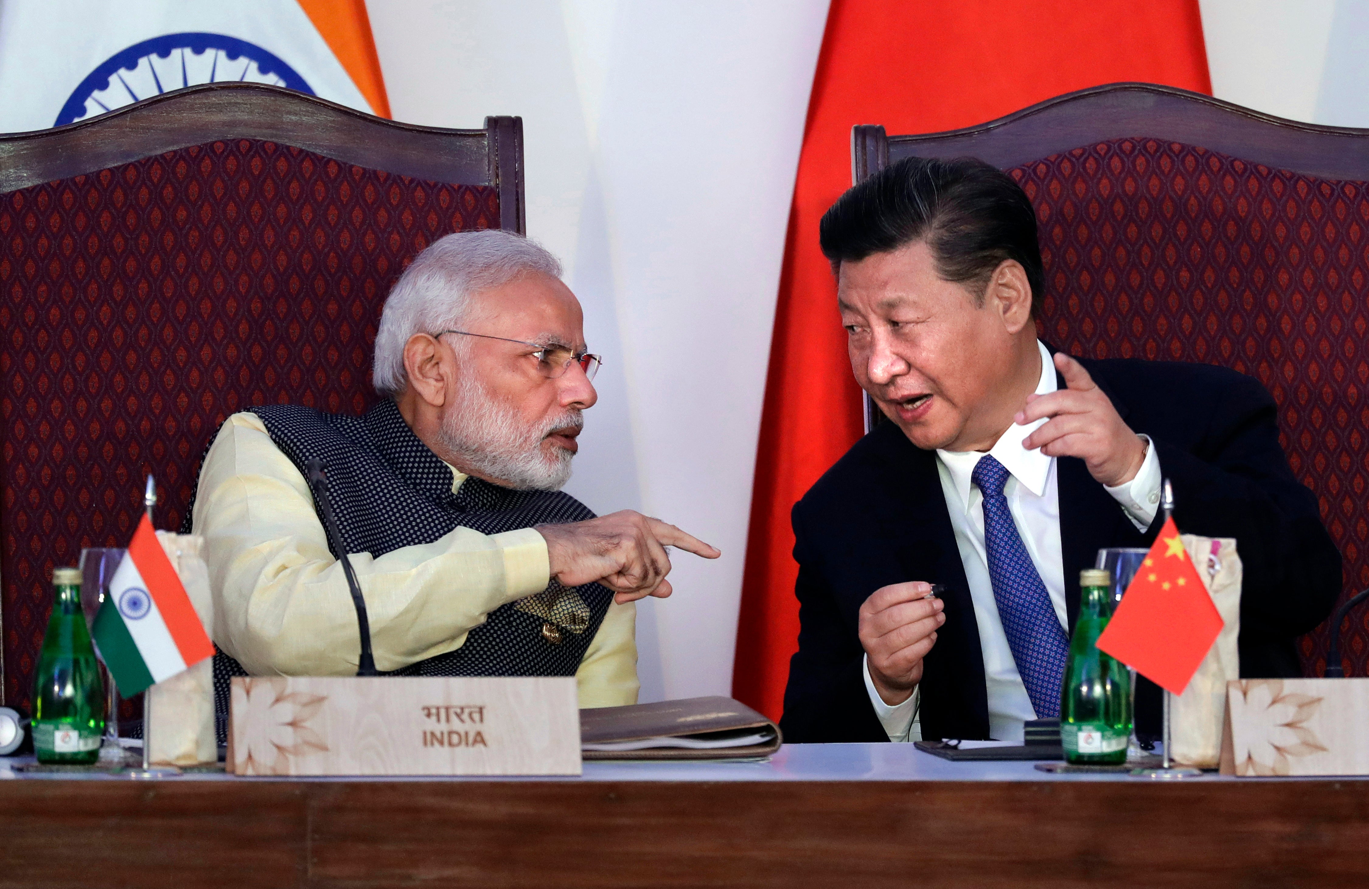 File: Indian prime minister Narendra Modi, left, talks with Chinese president Xi Jinping at a signing ceremony by foreign ministers during the BRICS summit in Goa, India, 16 October 2016
