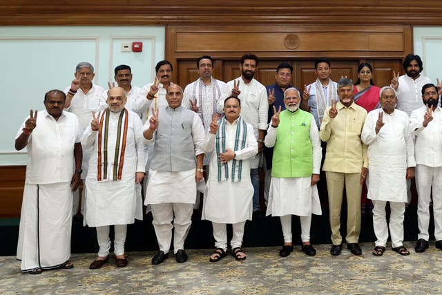 <p>Narendra Modi, centre, poses for a photograph with senior leaders of the Bharatiya Janata Party (BJP) and to his left, Telugu Desam Party leader N Chandrababu Naidu, and Janata Dal (United) leader Nitish Kumar</p>