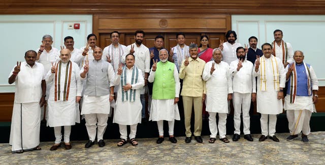 <p>Narendra Modi, centre, poses for a photograph with senior leaders of the Bharatiya Janata Party (BJP) and to his left, Telugu Desam Party leader N Chandrababu Naidu, and Janata Dal (United) leader Nitish Kumar</p>