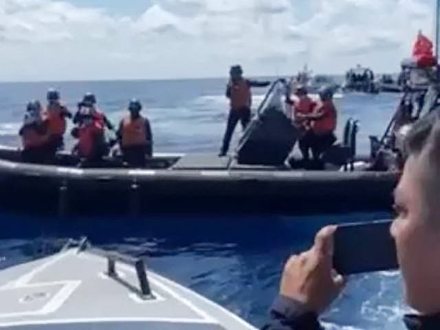 <p>Photo released by Philippine coast guard shows a Chinese boat blocking the evacuation mission in the South China Sea</p>