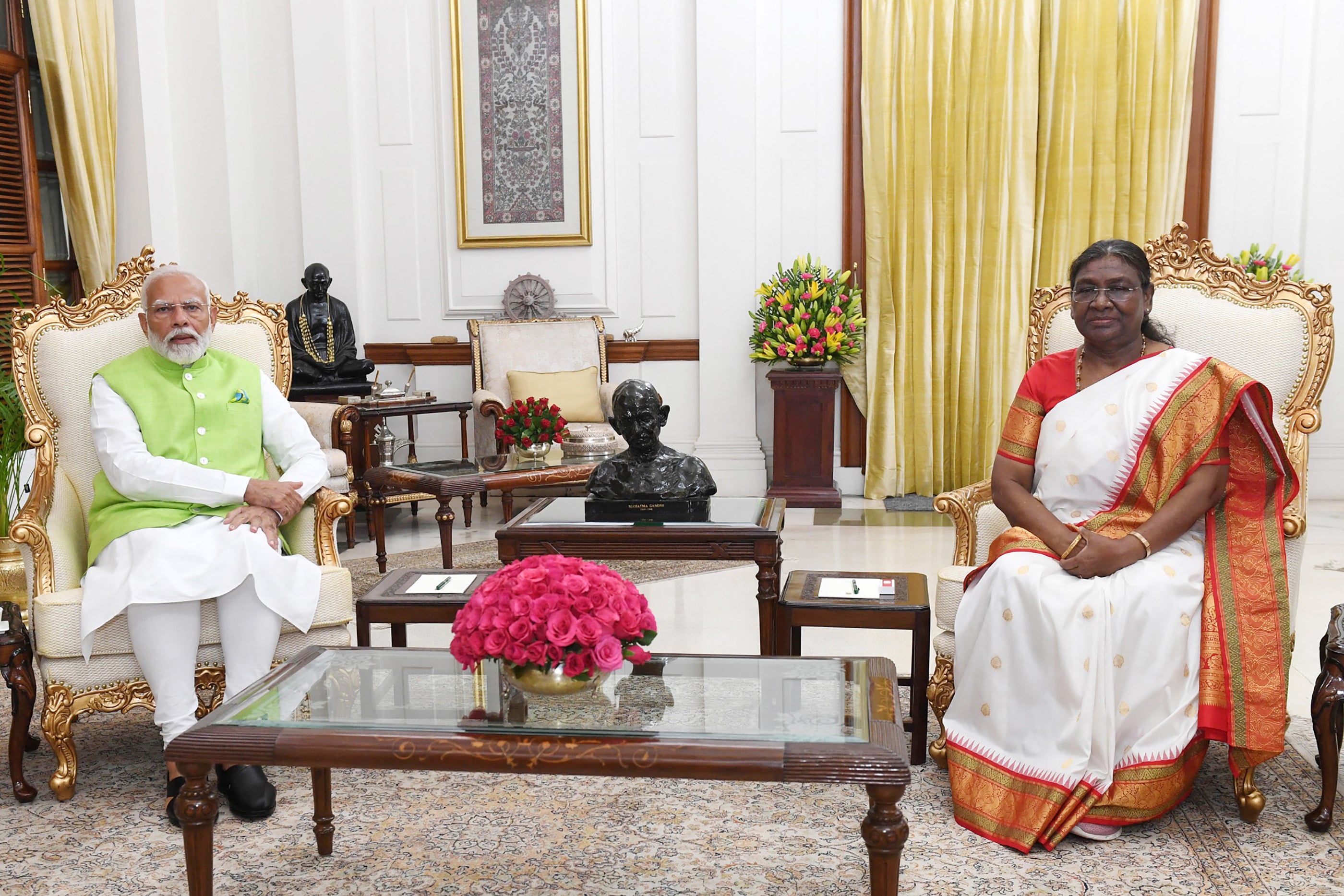 This handout photograph taken on 5 June 2024 and released by the Indian Press Information Bureau (PIB) shows prime minister Narendra Modi (L) speaking to president Droupadi Murmu after handing over his resignation to her at presidential palace Rashtrapati Bhavan in New Delhi