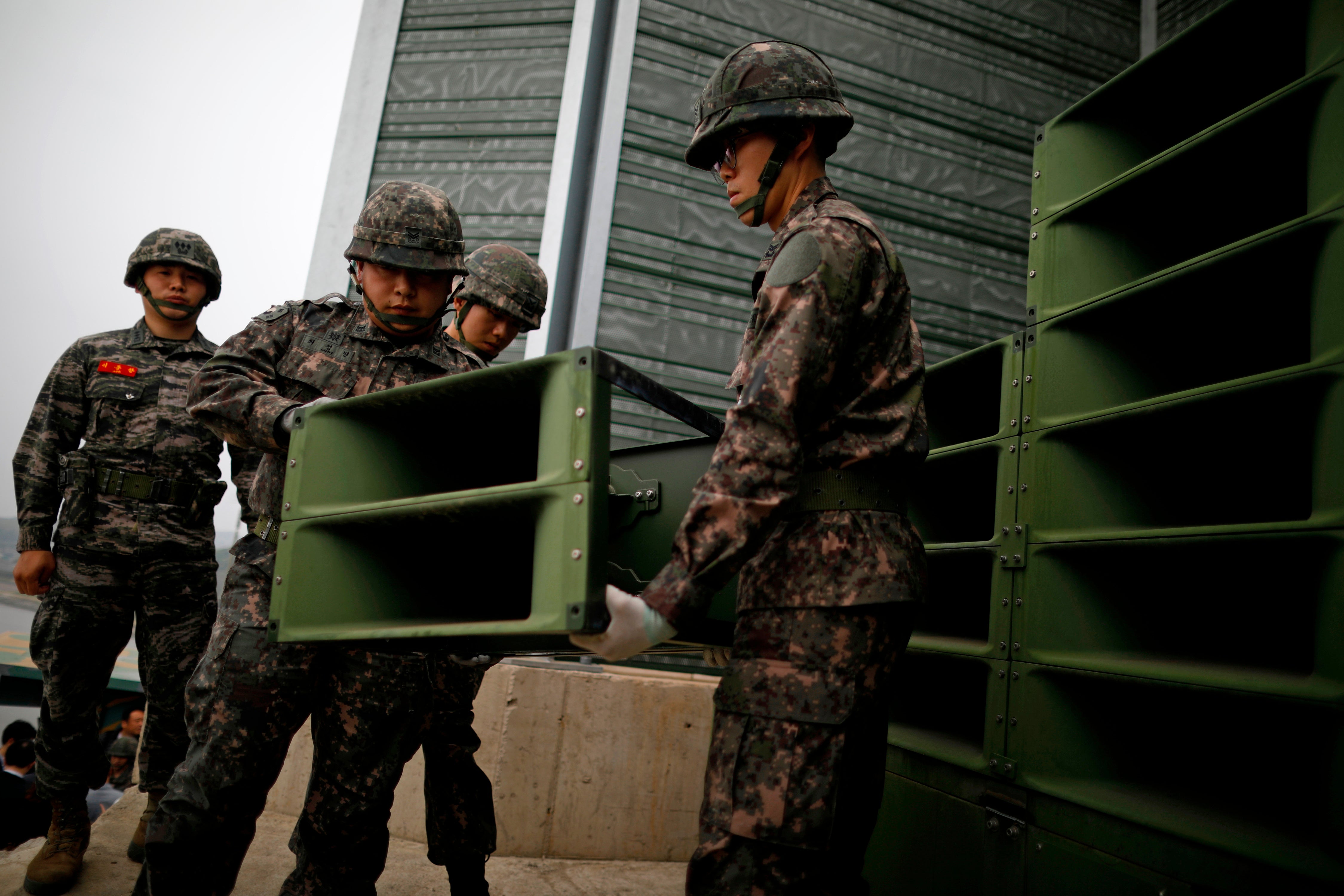 South Korean soldiers dismantle loudspeakers set up for propaganda broadcasts near the demilitarized zone separating the two Koreas in Paju, South Korea, on 1 May 2018