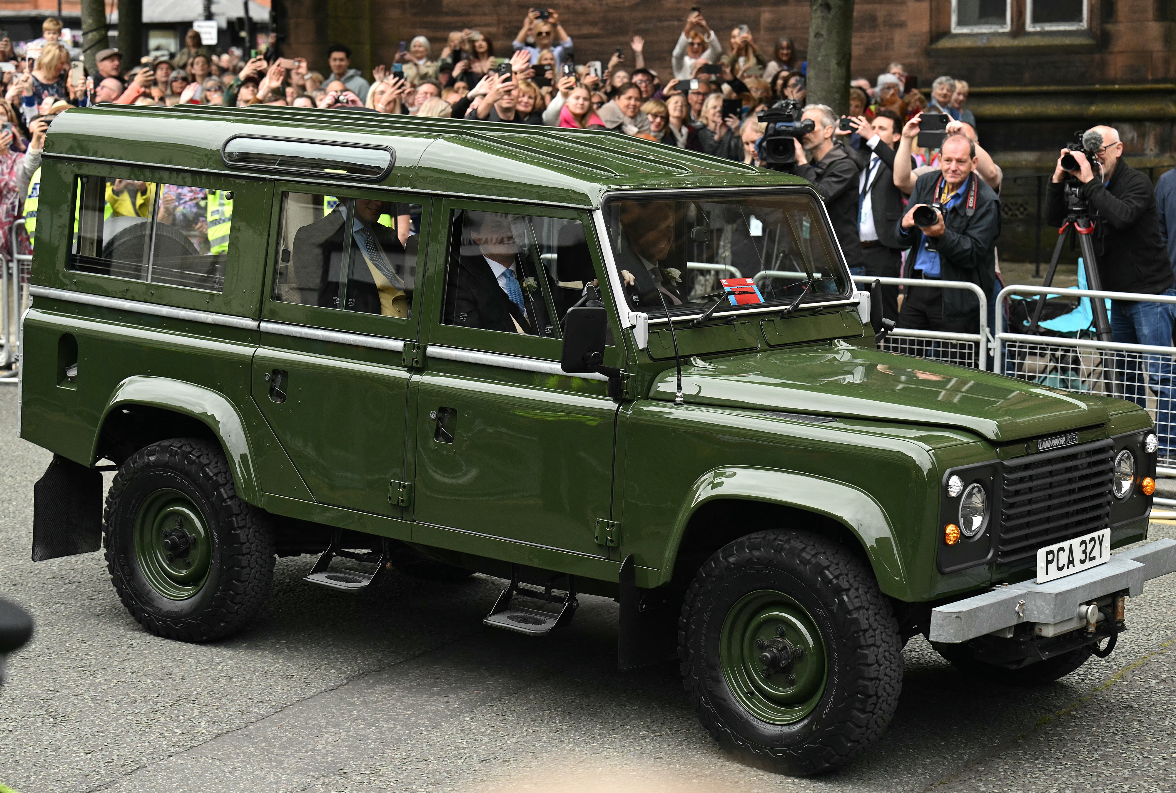 The Duke arrives in a green Land Rover vehicle at the cathedral