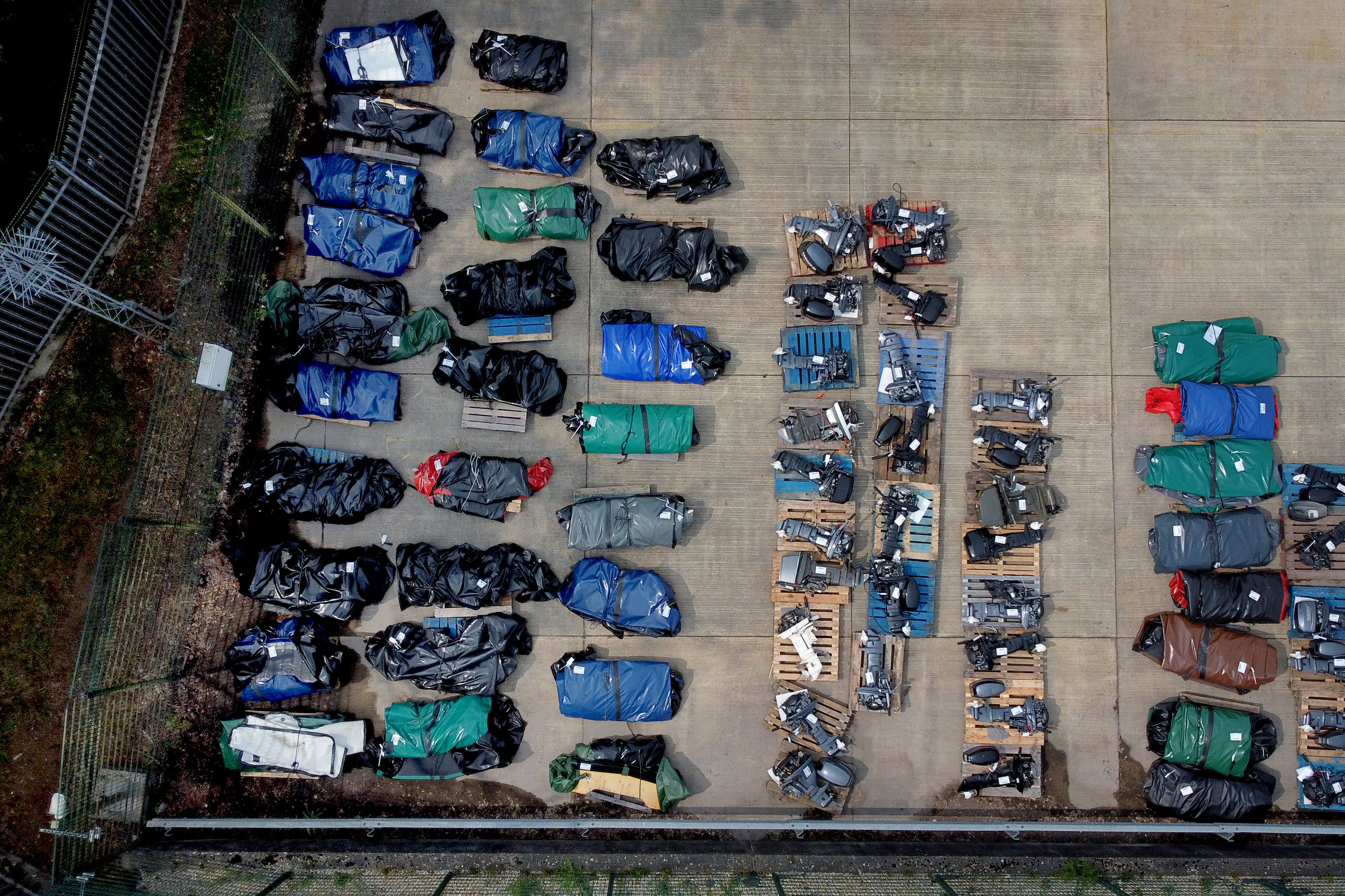 Small boats and engines used to cross the Channel by people thought to be migrants at a warehouse facility in Dover, Kent (Gareth Fuller/PA)