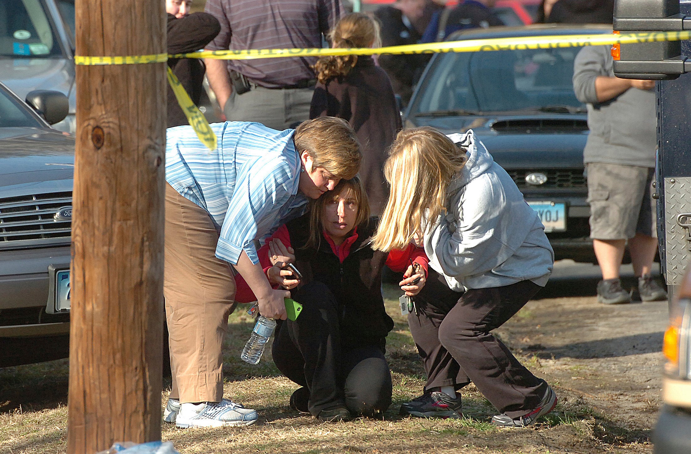 People are comforted near Sandy Hook Elementary School, Dec. 14, 2012 in Newtown, Conn