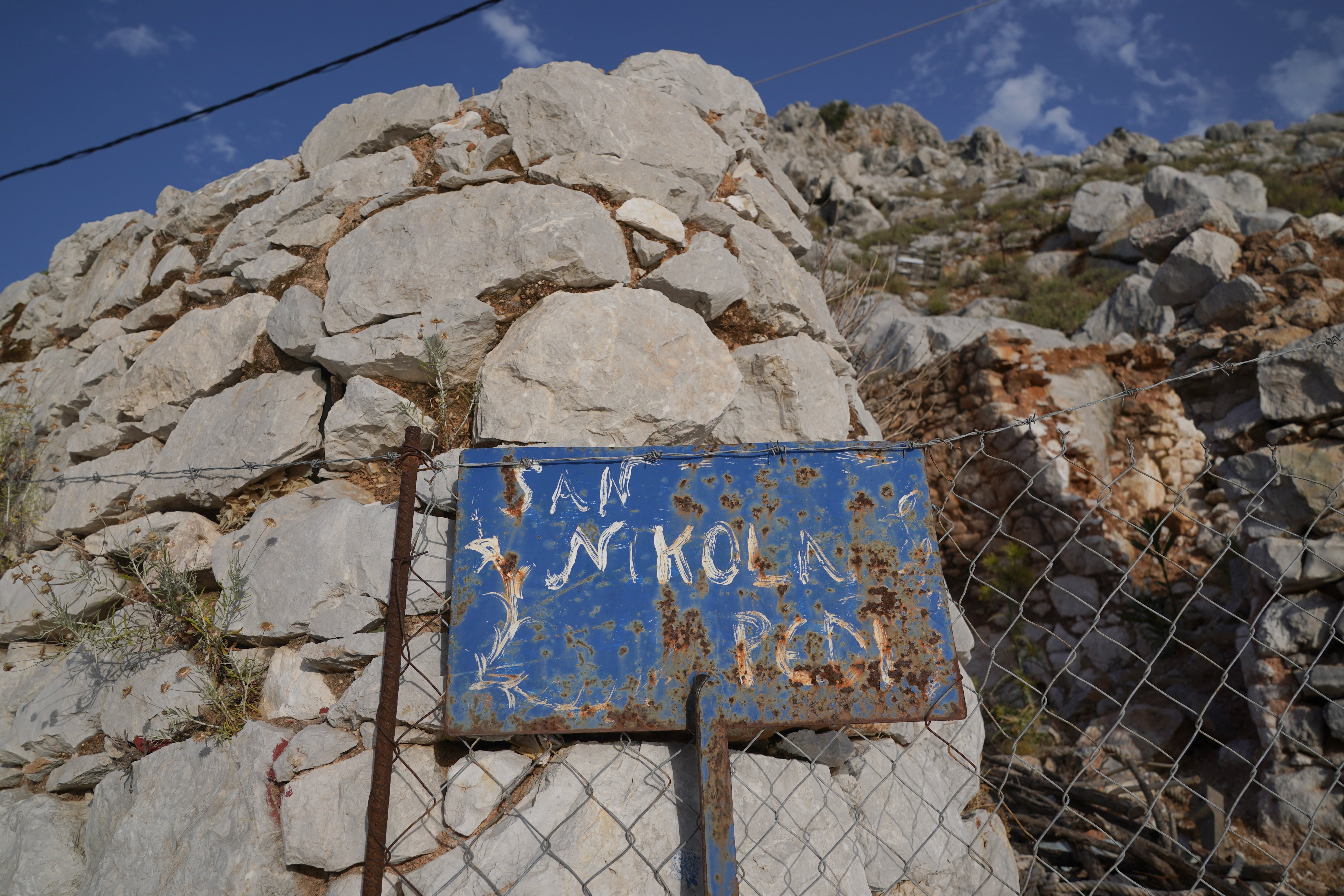 A sign reads Saint Nikolas in the Pedi district of Symi, Greece, where a search and rescue operation is under way for TV doctor and columnist Michael Mosley after he went missing while on holiday