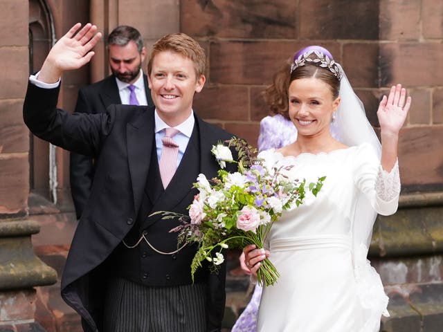 <p>Olivia Henson and Hugh Grosvenor, the Duke of Westminster waving to the crowds </p>