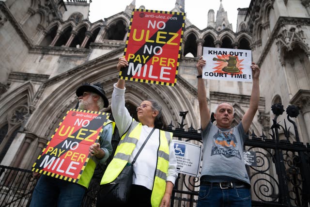 Anti-Ulez campaigners stage a demonstration outside the Royal Courts of Justice in central London (James Manning/PA)