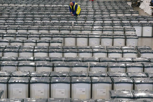 Election warehouse manager Michael Leonard among ballot boxes in Dublin (PA)