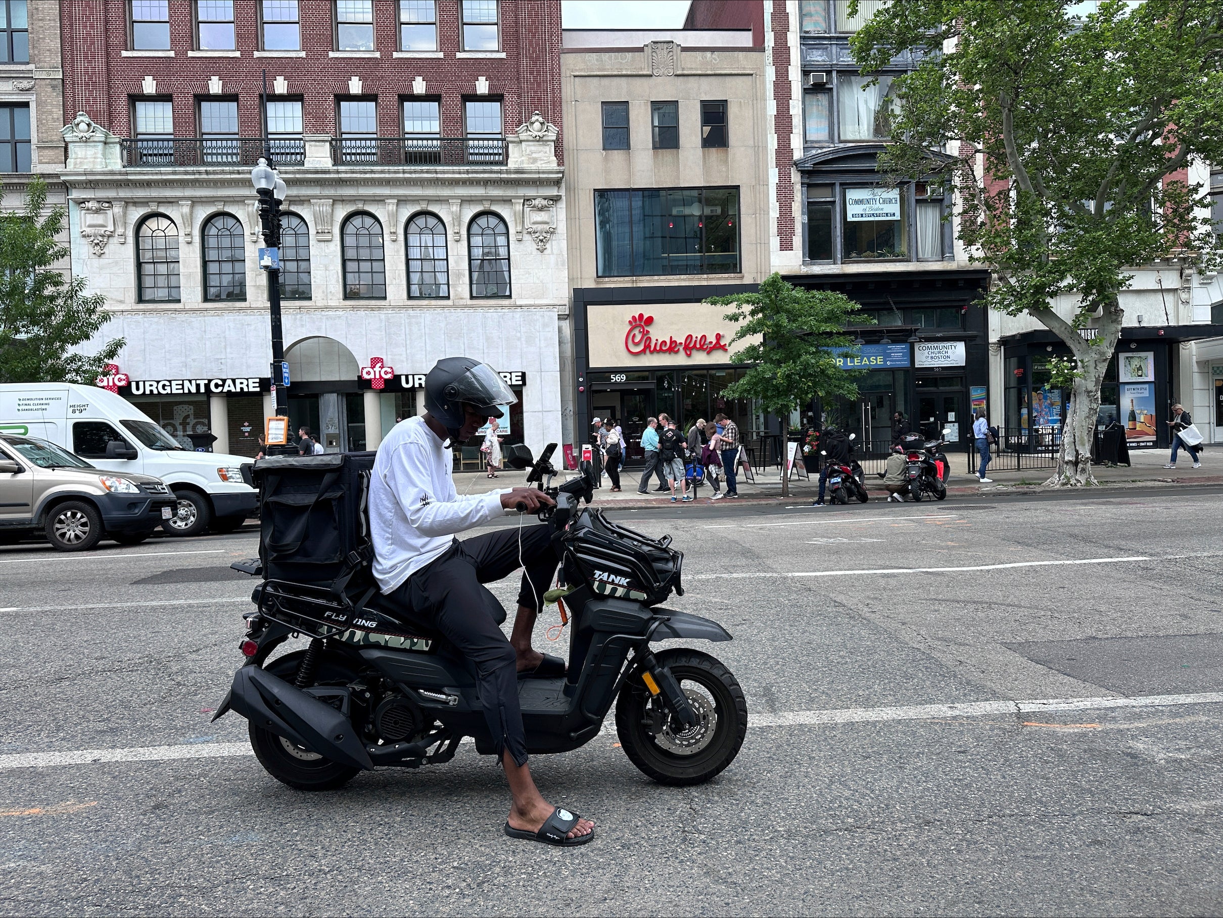 Delivery scooters are parked as drivers wait to pick up food for delivery, Thursday, June 6, 2024, in Boston