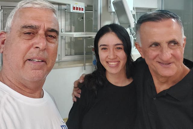 <p>Noa Argamani, a rescued hostage, stands with her father Yakov and a family friend Nir Givon, in Ramat Gan</p>