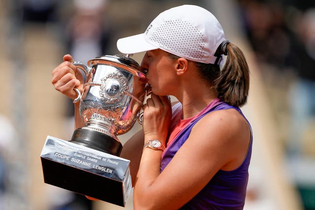 Iga Swiatek seals her fourth French Open win with a kiss (Thibault Camus/AP)