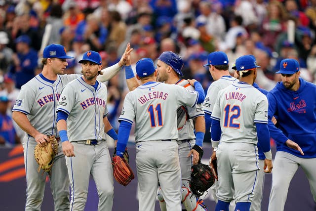 New York Mets catcher Luis Torrens (centre, rear) is congratulated by his team-mates after making a double play to finish the match (Zac Goodwin/PA)