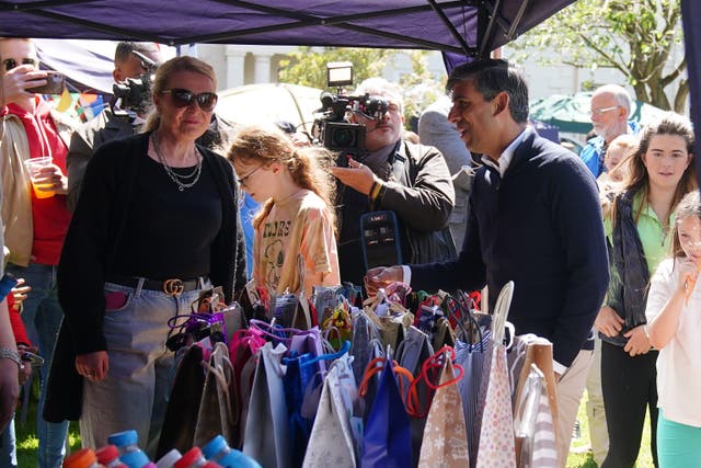 Prime Minister Rishi Sunak talking to a person at a village fete while on the General Election campaign trail (PA)