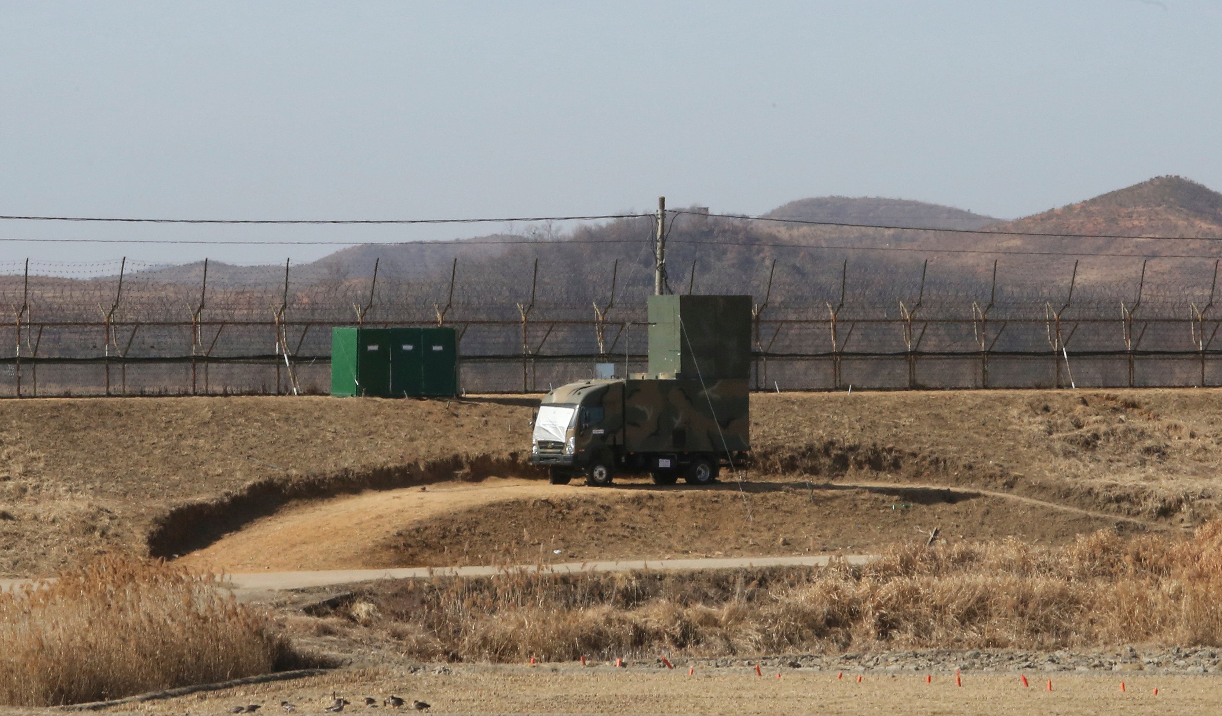 A South Korean military vehicle with loudspeakers is seen in front of the barbed-wire fence in Paju