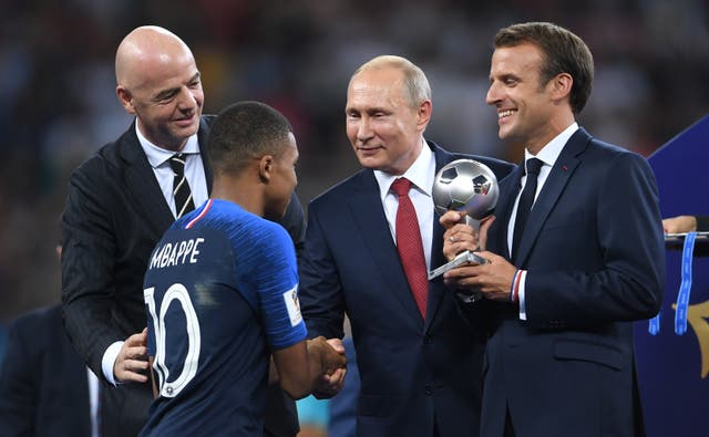 <p>Kylian Mbappe of France shakes hands with Vladimir Putin, President of the Russian Federation</p>