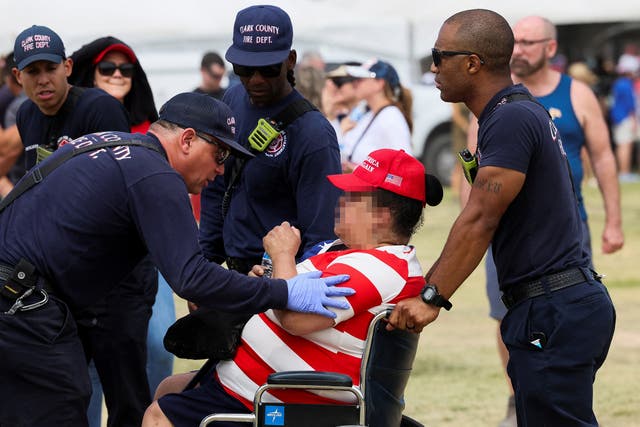 <p>A woman receives aid from firefighters as people wait for Republican presidential candidate and former U.S. President Donald Trump to attend a campaign event in Las Vegas, Nevada</p>