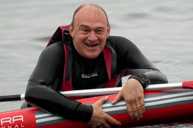 <p>Slippery politician? Ed Davey paddleboarding on Windermere during a campaign visit in May </p>