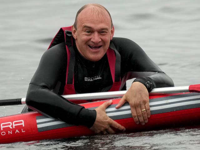 <p>Slippery politician? Ed Davey paddleboarding on Windermere during a campaign visit in May </p>
