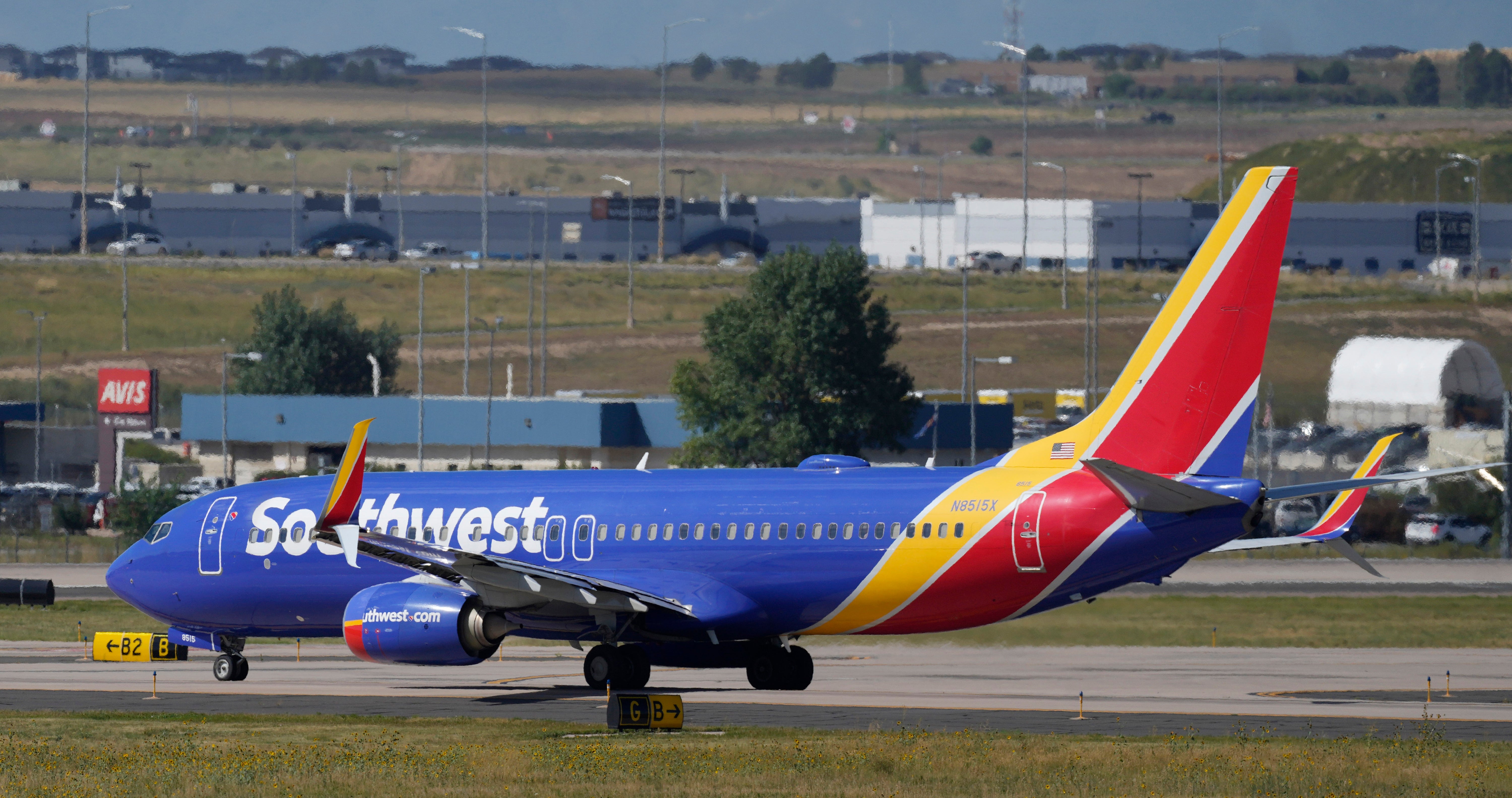 A Southwest Airlines jetliner waits on a runway for departure from Denver International Airport