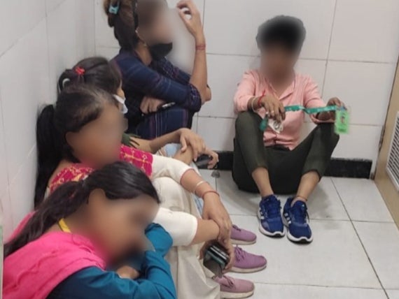 Women employees rest in the bathroom at an Amazon warehouse in Manesar, Haryana