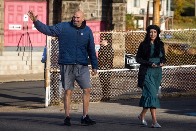 <p>John Fetterman alongside his wife Gisele Barreto Fetterman arrives to vote at the New Hope Baptist Church in Braddock, Pennsylvania, in November 2022</p>