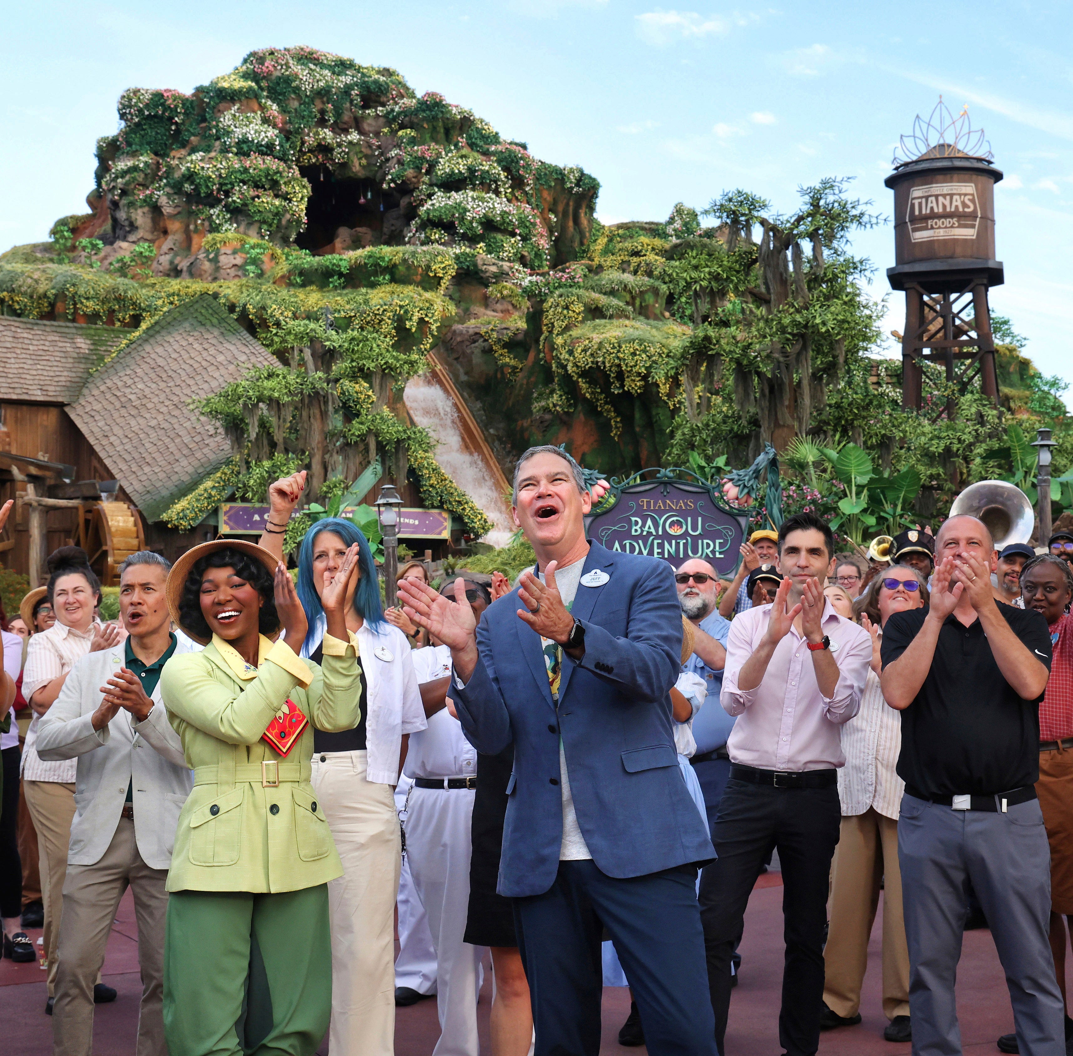 With Princess Tiana, Walt Disney World president Jeff Vahle cheers employees during a "Thank You Fête" honoring cast members at a preview event for Tiana's Bayou Adventure at the Magic Kingdom in Bay Lake