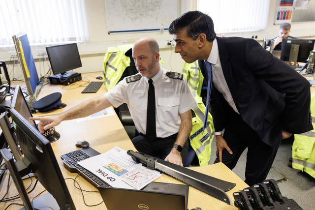 Prime Minister Rishi Sunak speaks to Police Sergeant Gavin Tuck while visiting Harlow Police Station in Essex (Dan Kitwood/PA)