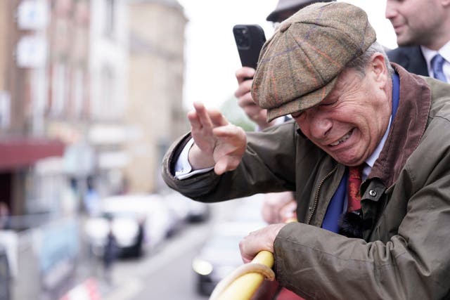 <p>Nigel Farage recoils as an object is thrown at him  </p>
