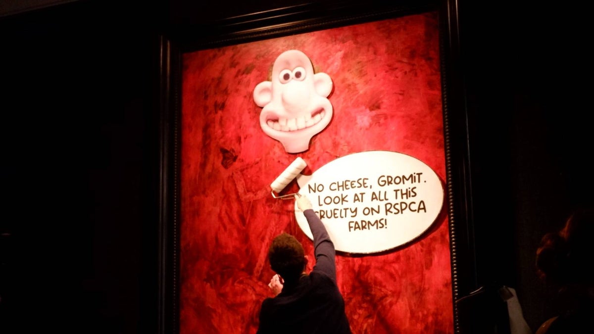 Protesters cover King Charles’s official portrait with Wallace and Gromit character