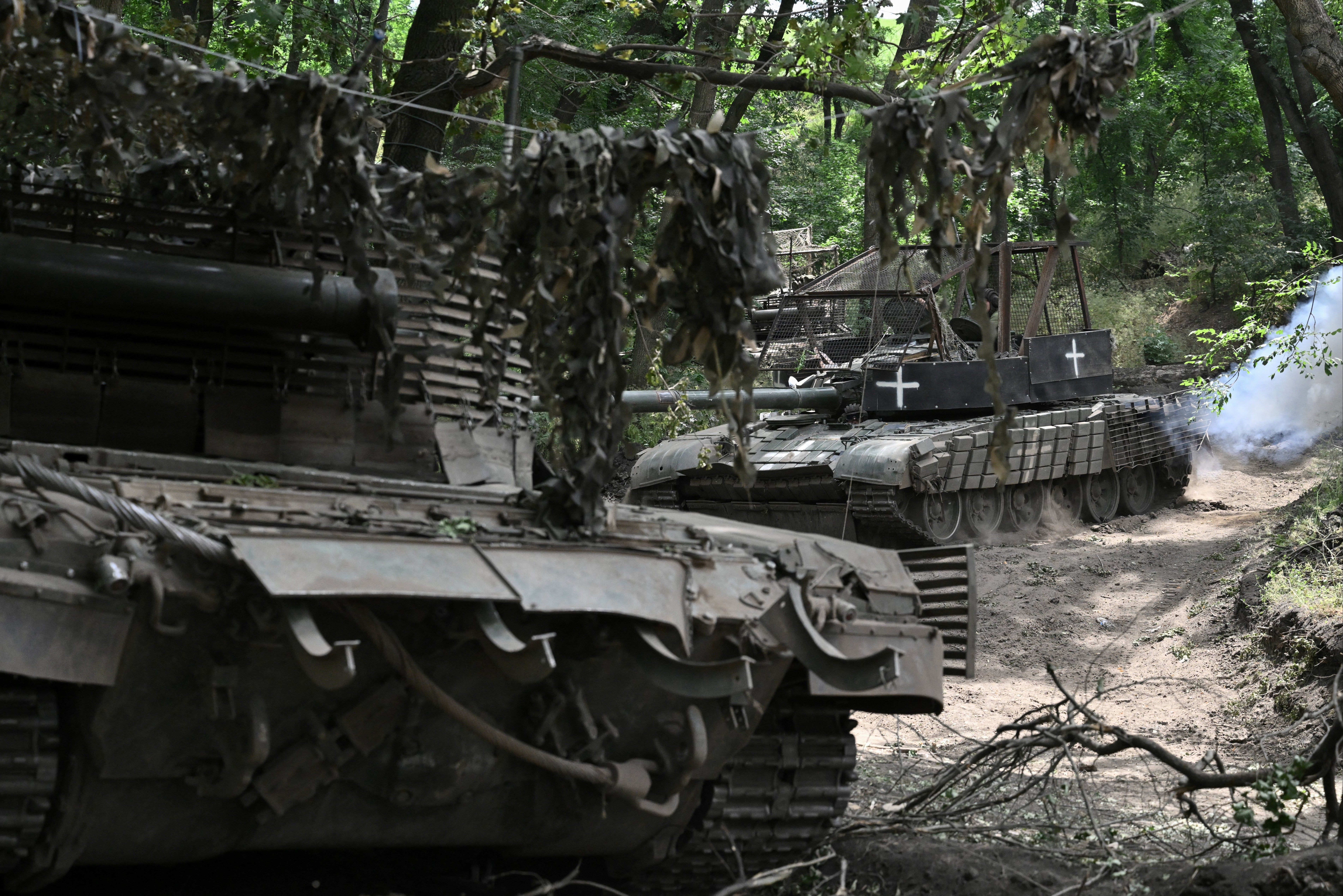 Ukrainian servicemen from the 59th brigade ride T-72 tanks in an undisclosed location in the Donetsk region