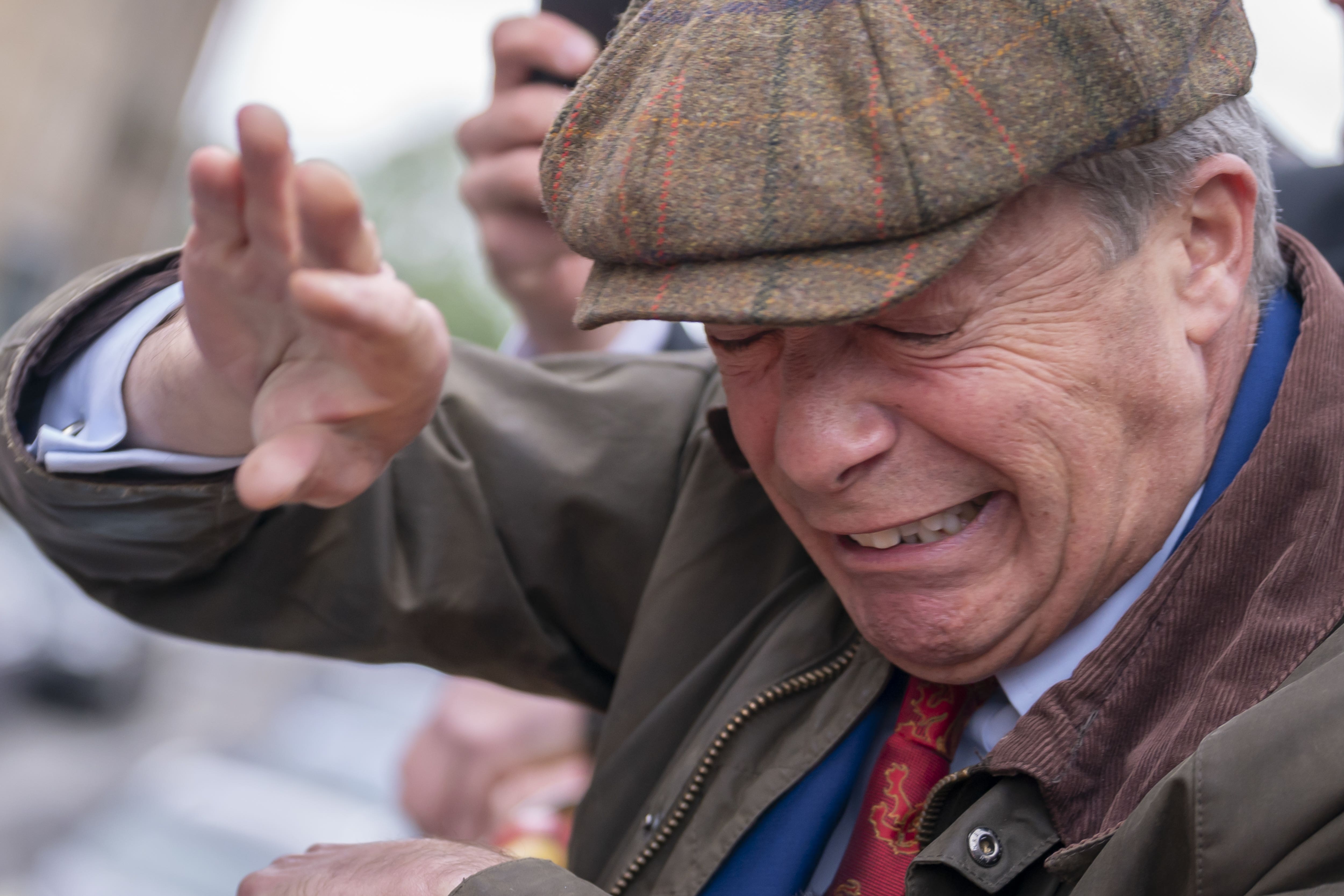 Nigel Farage reacts after something is thrown towards him on the campaign trail (Danny Lawson/pa)