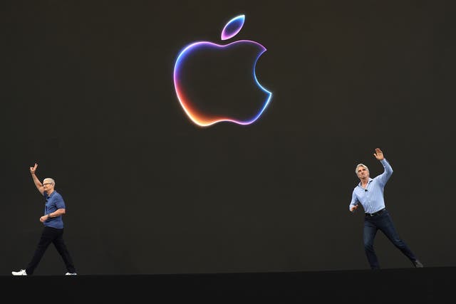 <p>Apple CEO Tim Cook (left) and senior vice-president of software engineering Craig Federighi greet attendees at the start of the Apple Worldwide Developers Conference earlier this week </p>