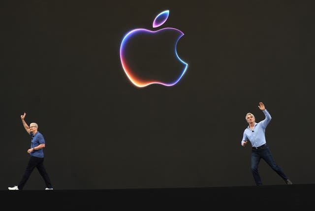 <p>Apple CEO Tim Cook (left) and senior vice-president of software engineering Craig Federighi greet attendees at the start of the Apple Worldwide Developers Conference earlier this week </p>