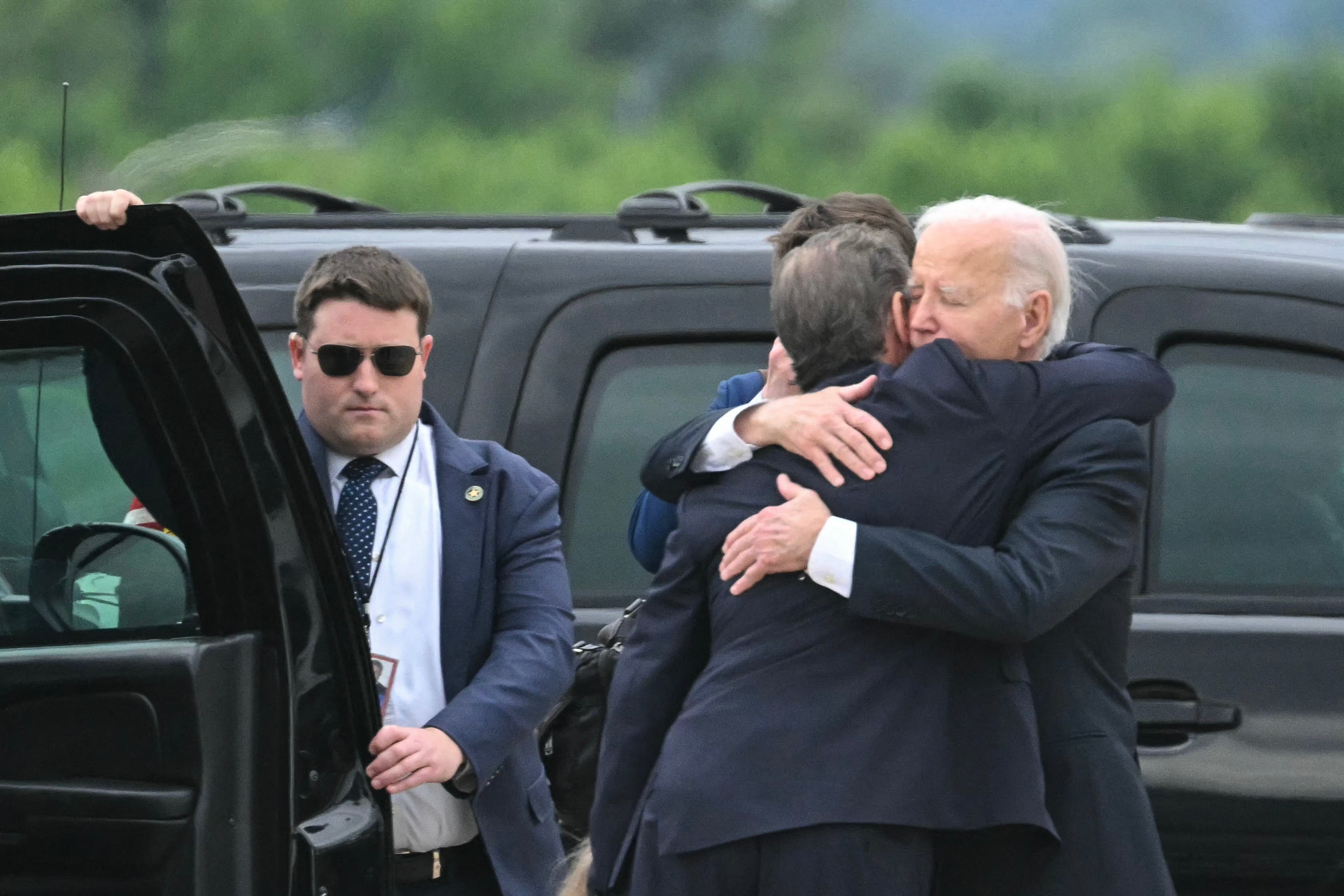 US President Joe Biden hugs his son Hunter Biden upon arrival at Delaware Air National Guard Base in New Castle, Delaware, on June 11, 2024