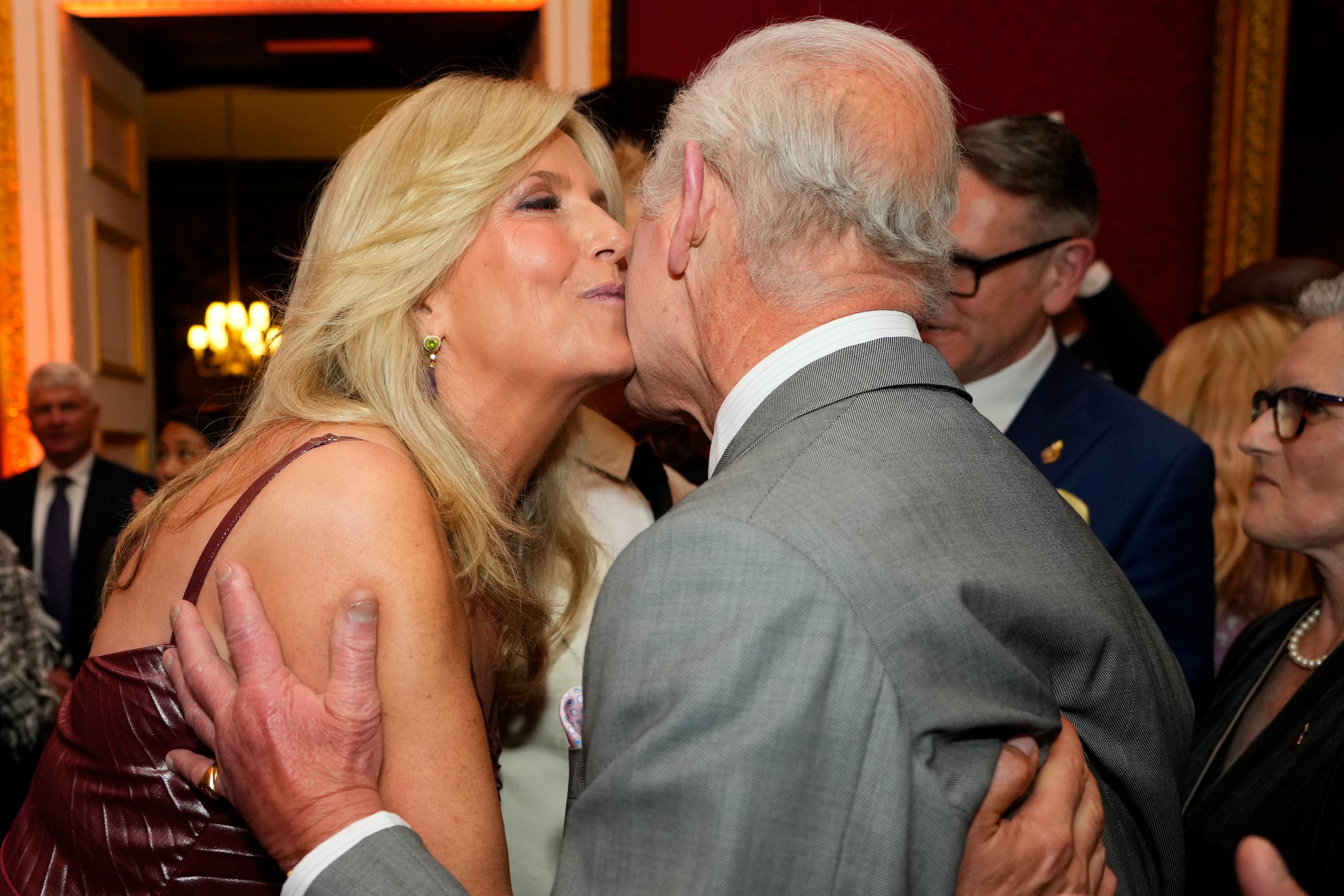 King Charles III right embraces Penny Lancaster as they attend the inaugural King's Foundation charity awards at St James's Palace