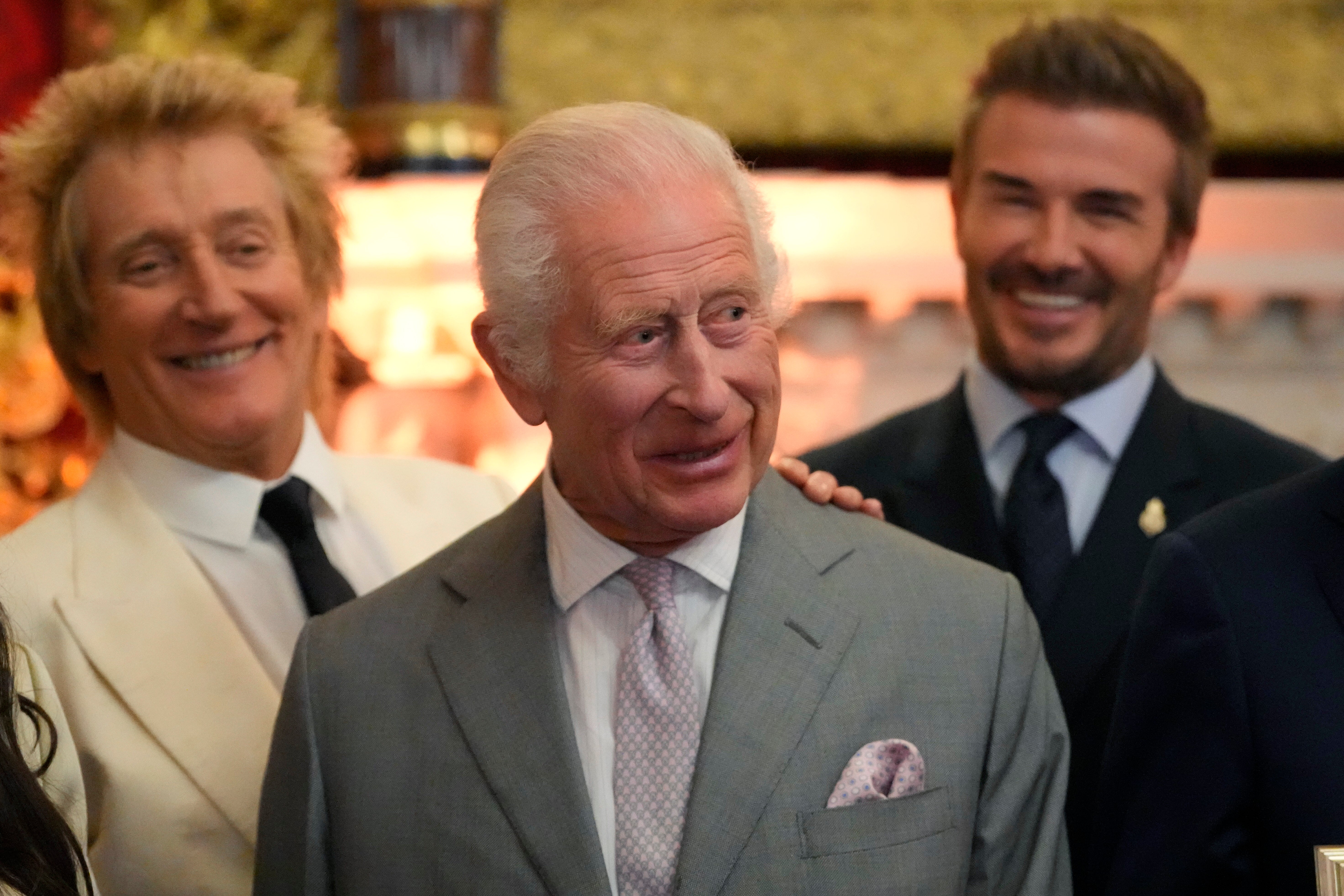 King Charles all smiles as he hosts David Beckham and Rod Stewart at awards ceremony