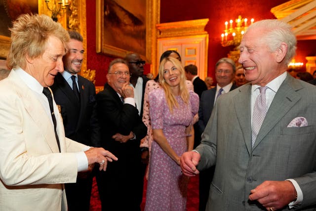 <p>King Charles laughs as he speaks with British singer Rod Stewart, former England player David Beckham and British actor Sienna Miller</p>