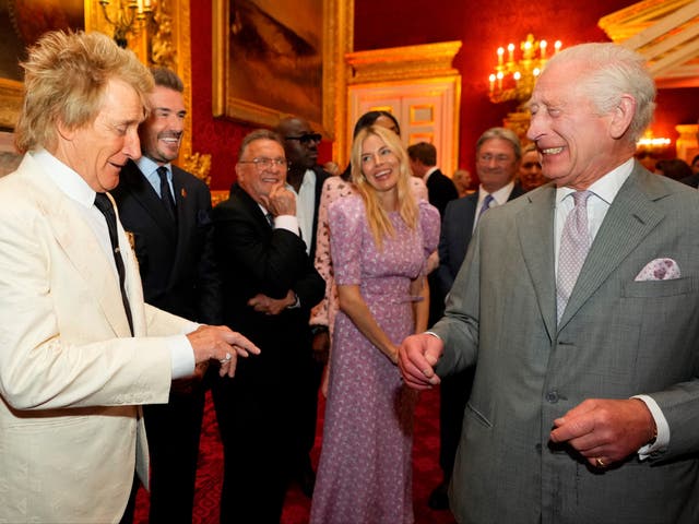 <p>King Charles laughs as he speaks with British singer Rod Stewart, former England player David Beckham and British actor Sienna Miller</p>