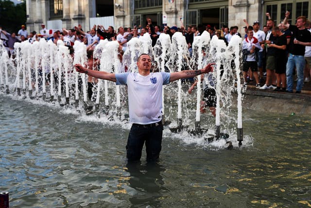 <p>An England fan revels in a water fountain during Euro 2016</p>