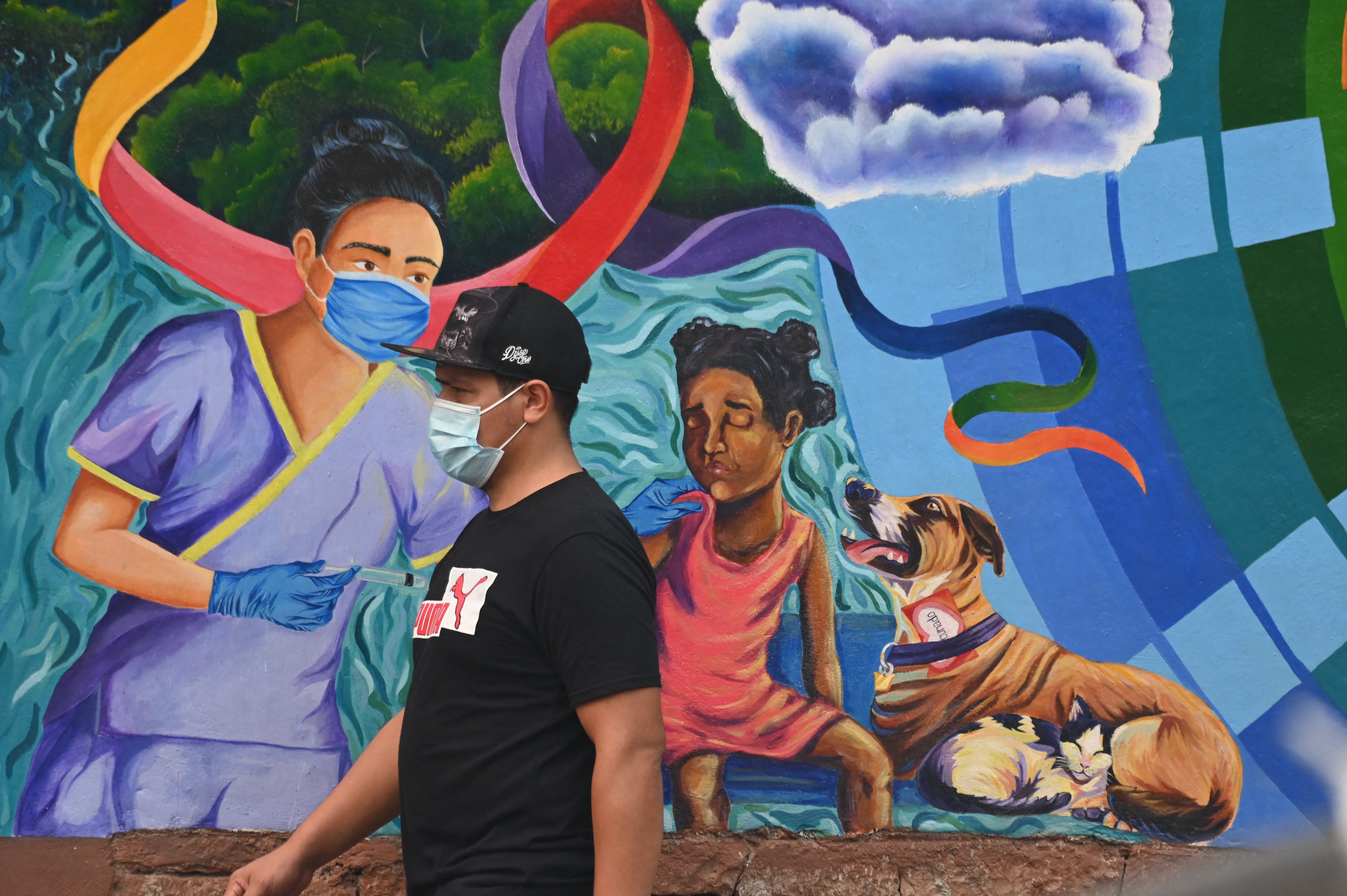 <p>A man wearing a face mask walks in Honduras after the country returned to the use of masks due to severe air pollution in May </p>